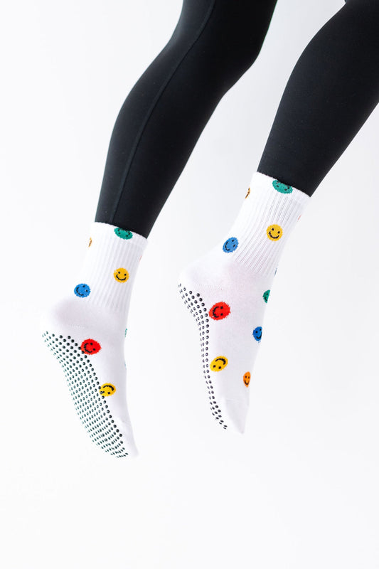 White socks with colorful polka dots on a white background