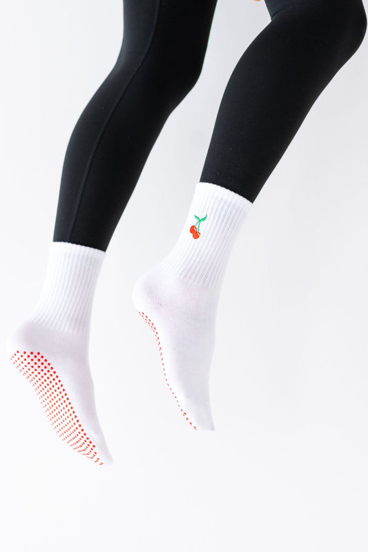 White socks with black tights on a white background