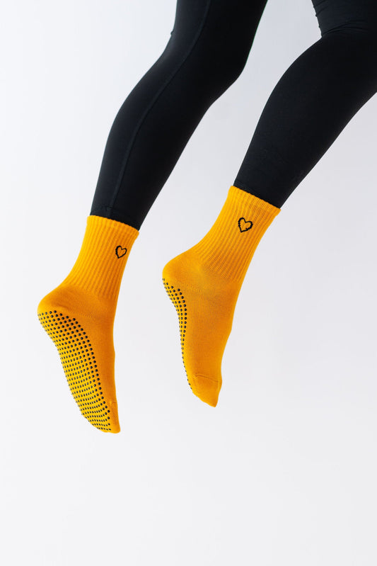 Yellow socks with black accents on a white background